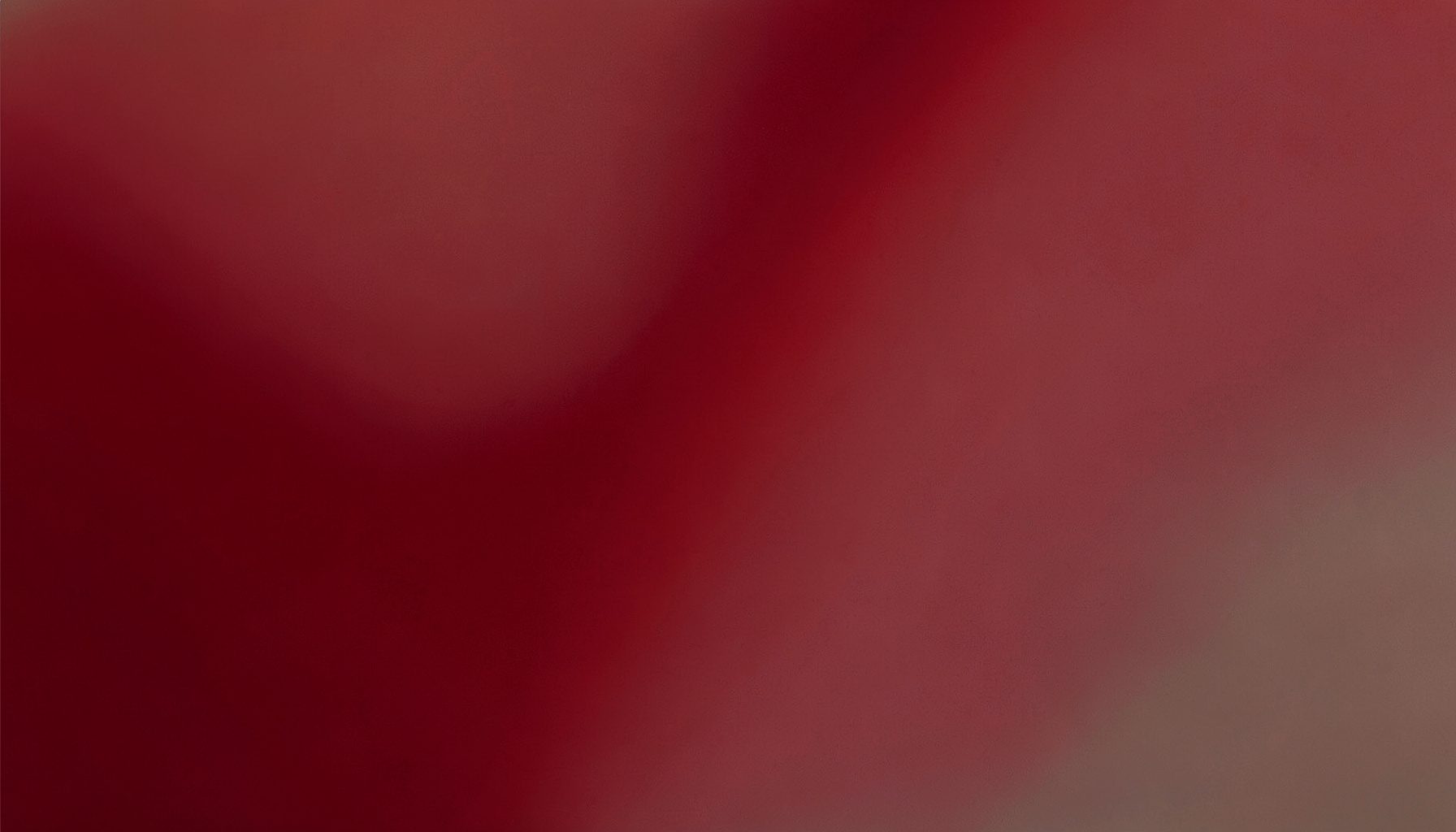 Deep crimson and warm grey abstract gradient block with subtle texture